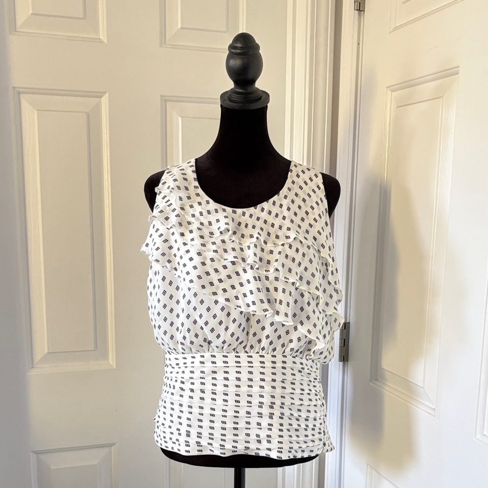 White House Black Market Sleeveless Blouse with Diamond Print and Ruffle Detail.